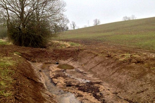 Figure 2: Bunded ditches, an earth bank inserted into a ditch with a small pipe to slow the flow of water and encourage the sediment to settle